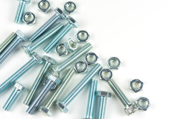 Various silver metal bolts. Fastening bolts with washers and nuts on a white background close-up. Copy space.