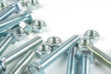 Various silver metal bolts. Fastening bolts with washers and nuts on a white background close-up....
