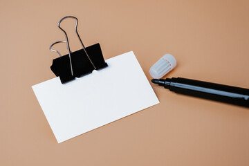 Still life, business, office supplies or education concept : Top view image of blank business card and black pen on beige background, ready for adding or mock up