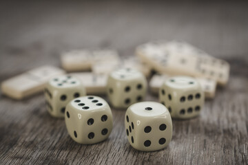Dice and dominoes on wooden table, casino luck