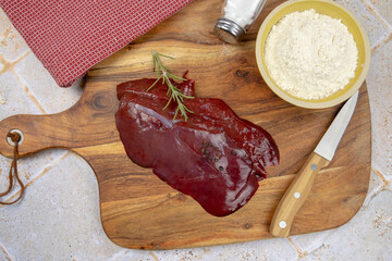  slice of raw liver on a cutting board