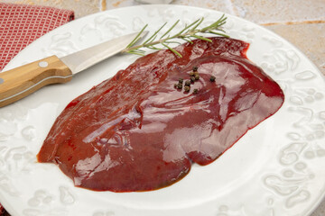 slice of raw liver in a plate