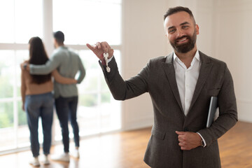 Portrait Of Smiling Real Estate Agent Holding And Showing Key