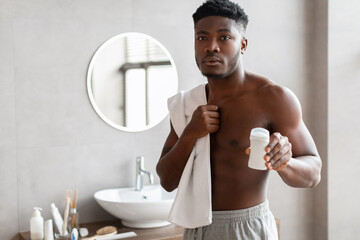 Handsome African American Male Advertising Antiperspirant Stick In Bathroom