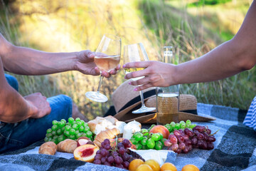 couple in love drinks wine at a picnic. Selective focus