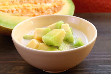 Closeup of Thai Melon in Chilled Sweet Coconut Milk with Blurry Fresh Fruit in Background