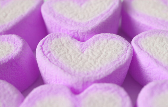 Closeup of Pastel Purple and White Heart Shaped Marshmallow Candies in Rows