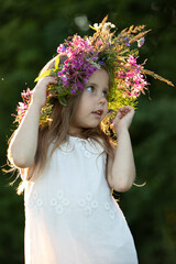 Obraz premium beautiful little girl in a wreath. High quality photo