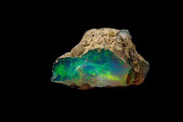 macro mineral stone rare and beautiful opals on a black background