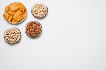 Nuts and snacks, a snack for beer on a white solid background.