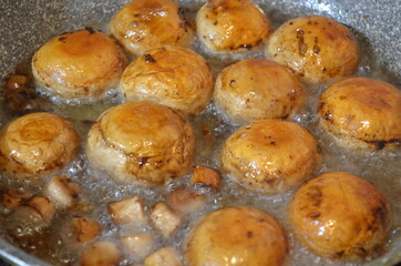 mushrooms are cooked in a frying pan