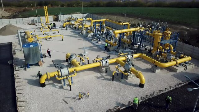 a group of industrial workers at a refinery - oil refining equipment and equipment