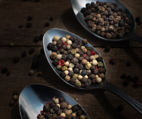 Various colored pepercorns on a dark background
