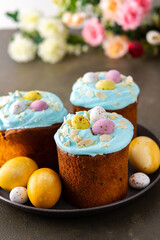 Festive table, Easter cake decorated with glaze, almond flakes and colorful eggs, Happy Easter