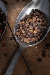 Various colored pepercorns on a dark background