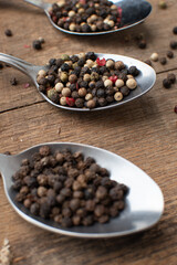 Various colored pepercorns on a dark background