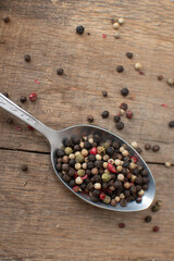 Various colored pepercorns on a dark background