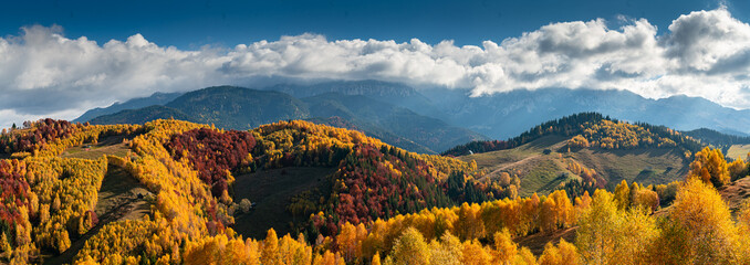Landmarks of Romania. Travel to Transylvania. Autumn view to the beautiful authentic villages from Rucar Bran Pass with traditional houses.