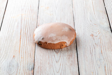 Freshly baked tasty bun on a white wooden table. Tasty baked goods straight from the bakery. White background.