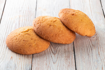 Freshly baked tasty bun on a white wooden table. Tasty baked goods straight from the bakery. White background.
