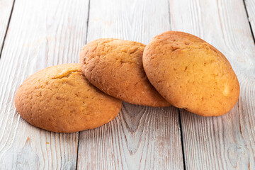 Freshly baked tasty bun on a white wooden table. Tasty baked goods straight from the bakery. White background.