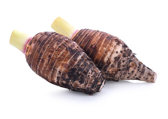 Taro root on old wooden background.