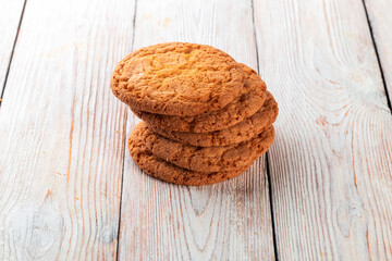 Oatmeal cookies on the white wooden background