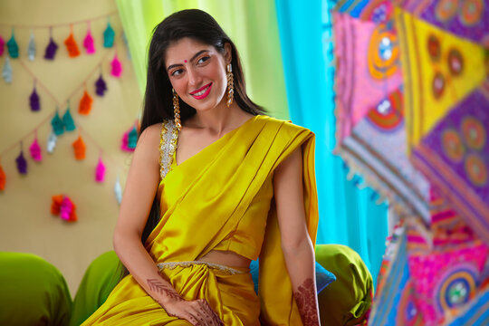 Portrait of an Indian bride in yellow saree during haldi ceremony
