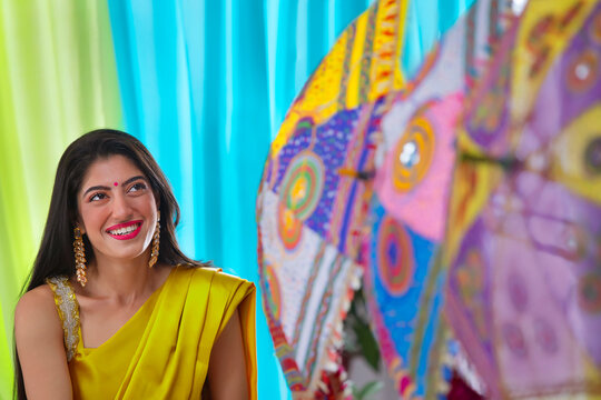 Portrait of an Indian bride in yellow saree during haldi ceremony