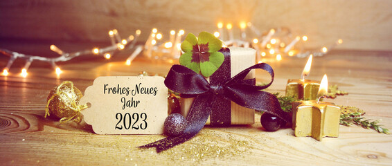 Frohe Neues Jahr 2023 means Happy New Year 2023- New year congratulations - gift box with lucky...