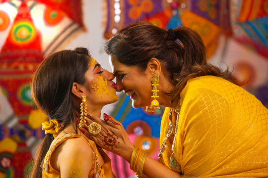 Daughter kissing her mother during Haldi Ceremony