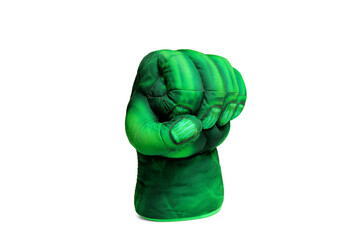 green hand clenched into a fist. superhero toy fist. comic. standing half-sided close-up. isolated on white background