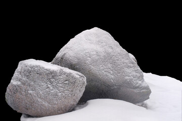 natural stone in snow isolated on black background