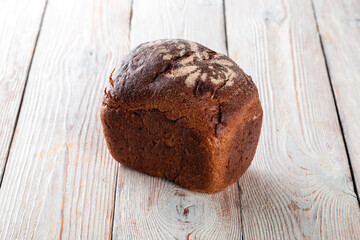 Freshly baked tasty bread on a white wooden table. Tasty baked goods straight from the bakery. White background.