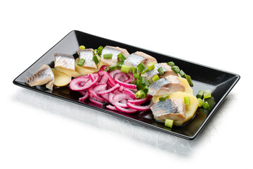 Appetizer with lightly salted herring, boiled potatoes and onions. Isolated on a white background