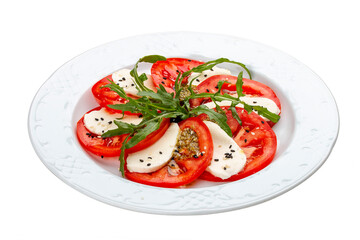 Caprese salad with mozzarella, tomatoes and pesto sauce. A traditional Italian dish. Isolated on a white background.