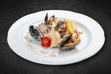 Rice with seafood: shrimp, squid and mussels. Isolated on a black background.