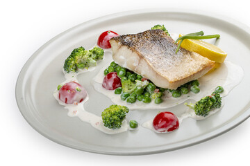 Pike perch on a vegetable pillow . Isolated on a white background.