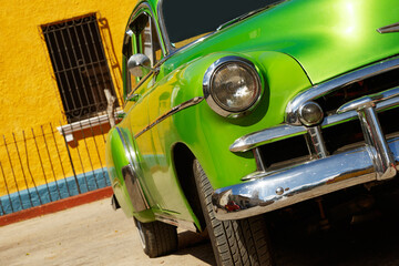 Shiny vintage green car parked on street