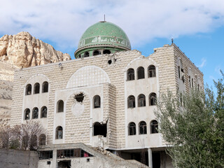 SYRIA. Maalul Monastery is located 60 km from Damascus. Nearby is the village of Kalamondin resembling an eagle's nest. The houses are built on the rocks by steps.