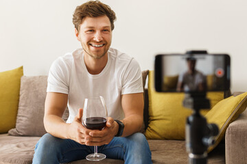 Sommelier blogger on sofa with a glass of wine
