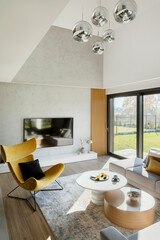 Stylish composition of living room interior with corner beige sofa, yellow armchair, coffee table...