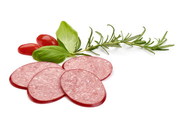 Salami sausage slices with basil leaves, close-up, isolated on white background.