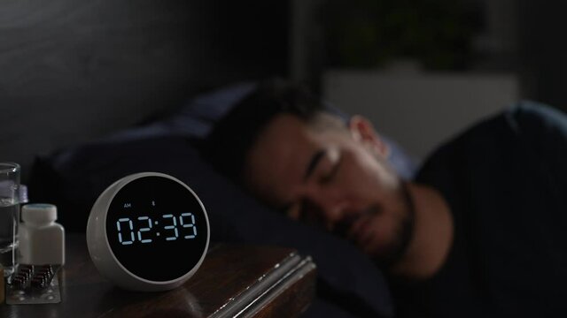 Depressed young Asian man lying in bed cannot sleep from insomnia