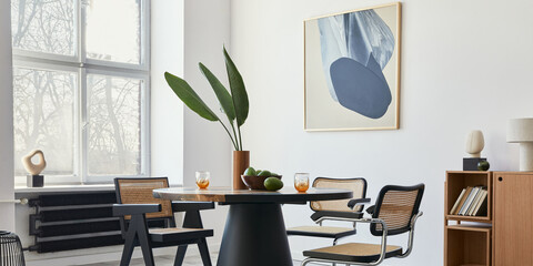 Stylish composition of dining room interior with design table, modern chairs, decoration, tropical...