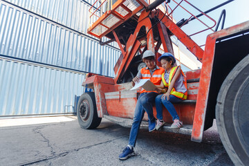 Man engineering and daughters sitting on forklift working with clipboard in container yard. work education and learning concept.