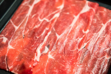 Sliced wagyu beef on a plate that has not yet been cooked