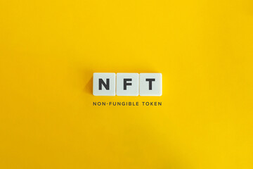 NFT (non-fungible token) banner and concept. Block letters on bright orange background. Minimal aesthetics. - obrazy, fototapety, plakaty