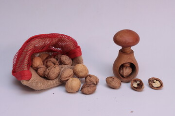 Walnuts and wooden nutcracker on white background