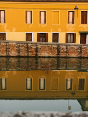 Fototapeta na wymiar building flashing in water in Italian village making symmetry 